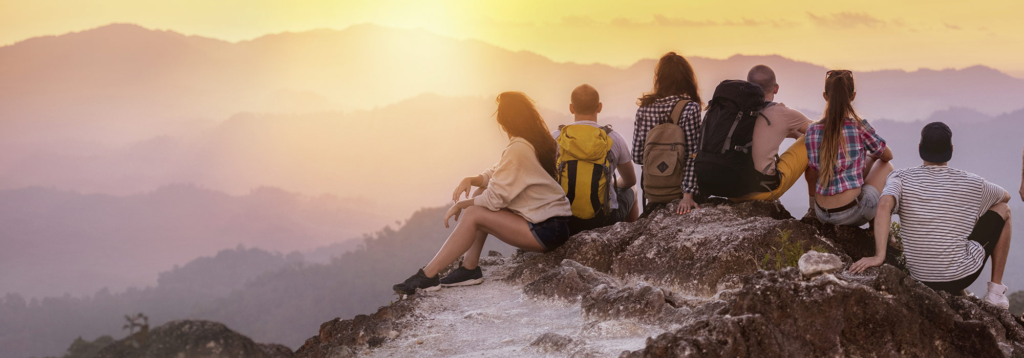 Group of hikers enjoying a scenic mountain sunrise view