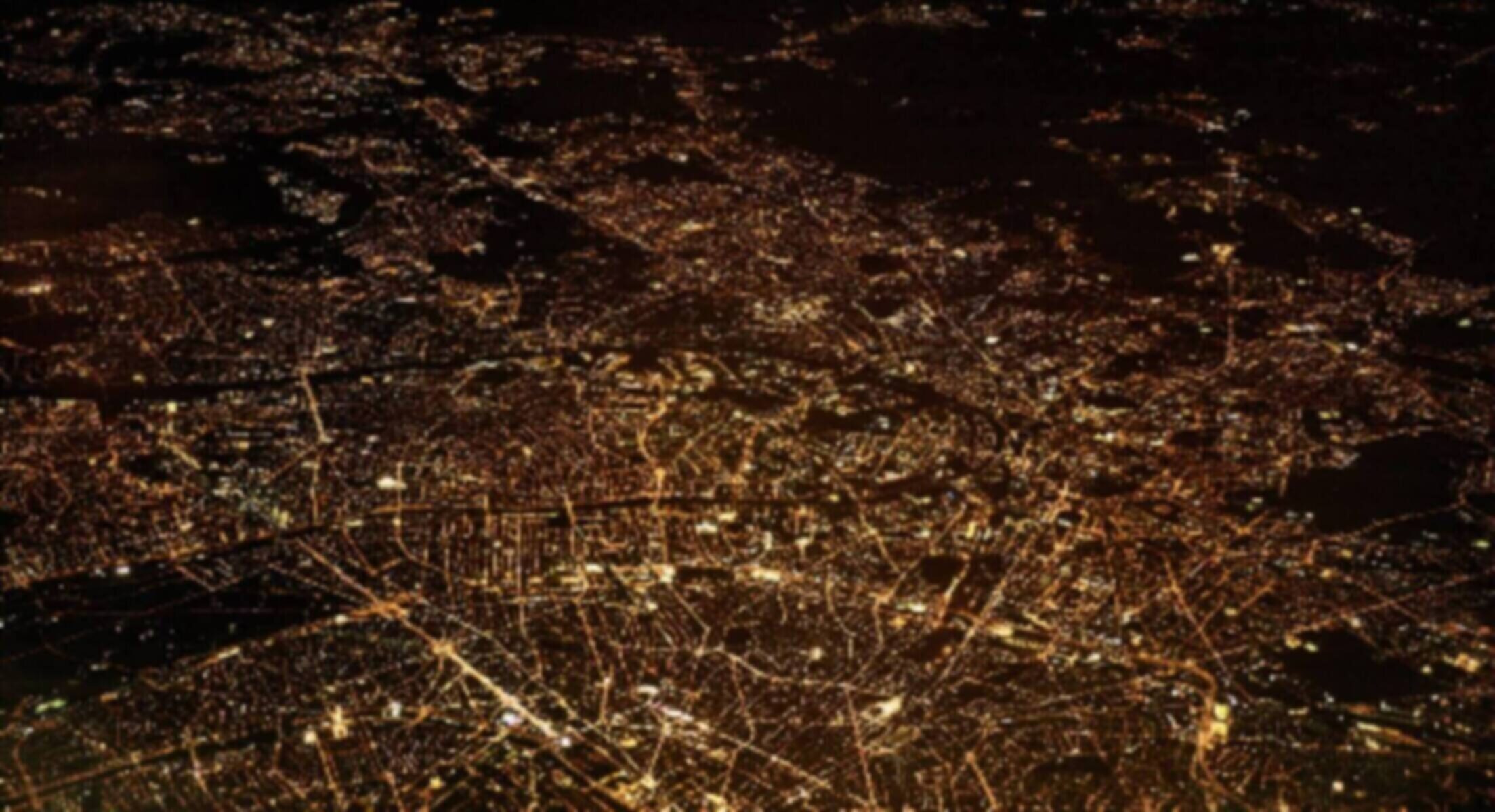 Aerial view of an illuminated cityscape at night.