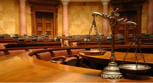Scales of justice in an empty courtroom