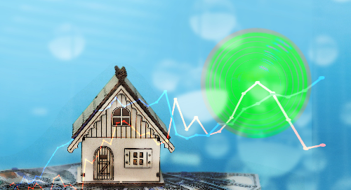Miniature house overlaid with fluctuating financial graph against a digital background.