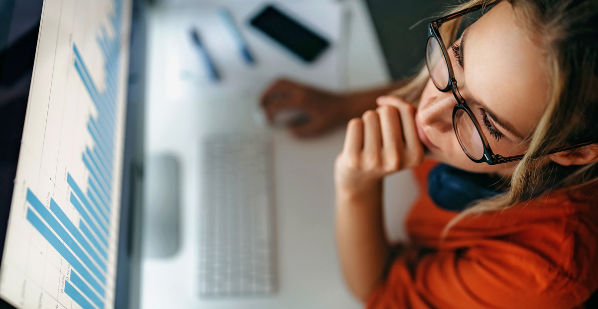 Woman analyzing data on a computer screen.
