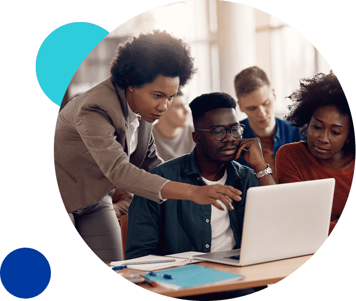 HigherEducation_LeverageData Group of diverse students collaborating on a laptop in a classroom setting.