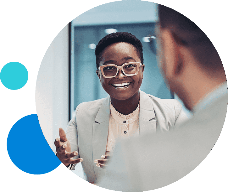 Professional woman in a business meeting, smiling and engaged in conversation.