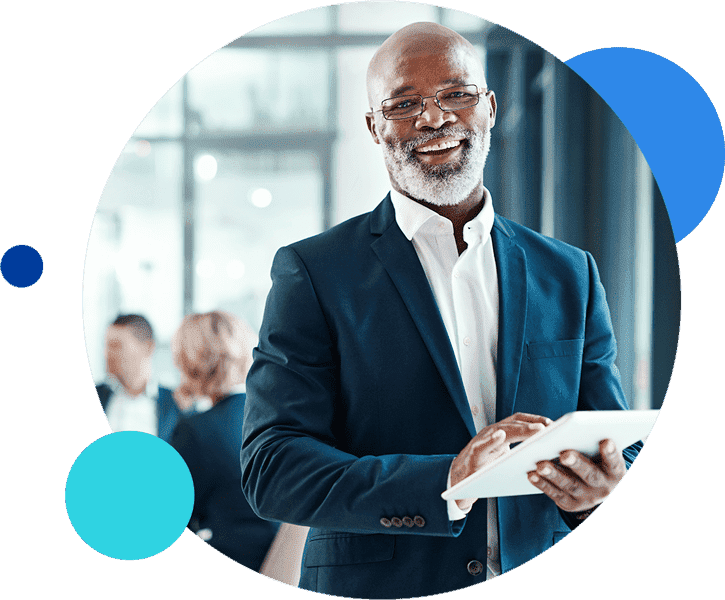 Smiling businessman using a digital tablet in an office setting.