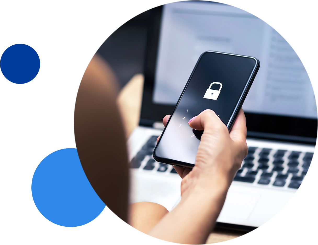 privacy-prioritized-inset Person unlocking smartphone with lock screen, in front of a laptop