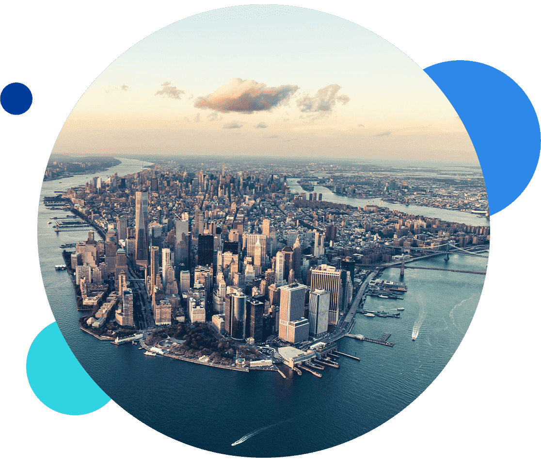 Aerial view of Manhattan skyline with surrounding rivers in the background.