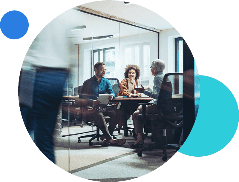 Meeting in modern office with glass walls and diverse colleagues discussing work.