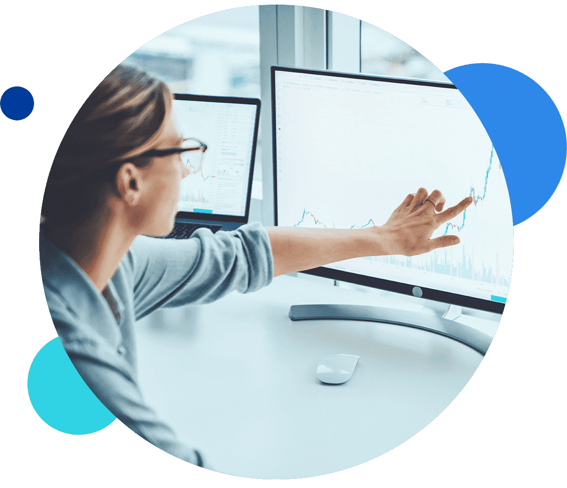 Person analyzing stock market data on a computer screen.