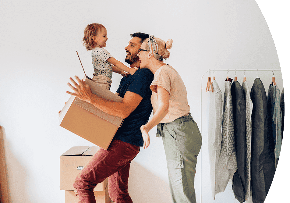 Family moving into a new home with packing boxes and clothing rack.