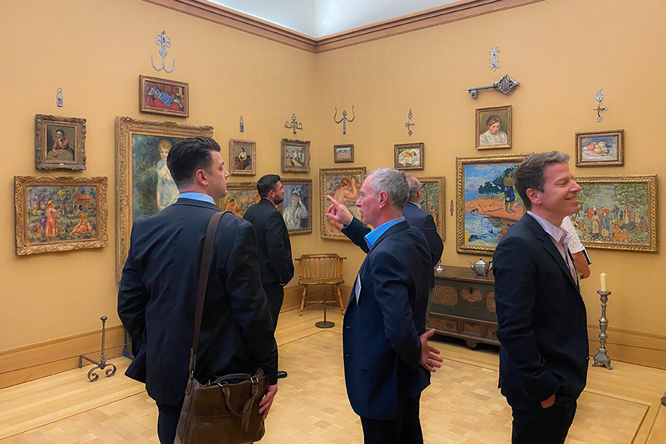 VIA-Barnes-Gallery Visitors admiring artwork in a museum gallery.