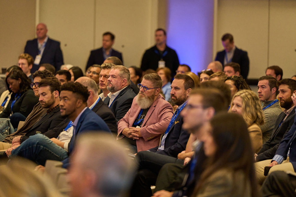 Audience attentively listening at a business conference.