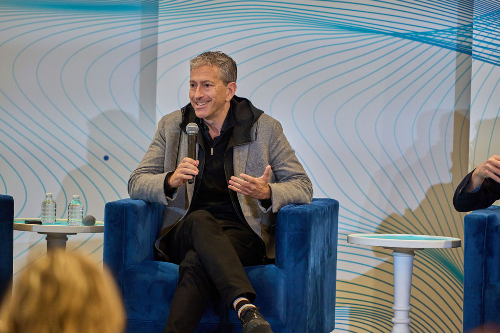 _P1_3889 Man speaking on stage during a panel discussion.