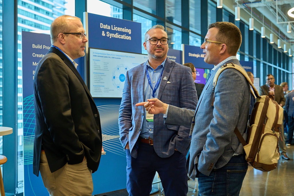 _P2_8190 Business professionals discussing data licensing at a conference.