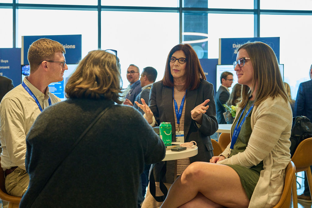 _P2_8264 Business professionals engaged in discussion at a networking event.