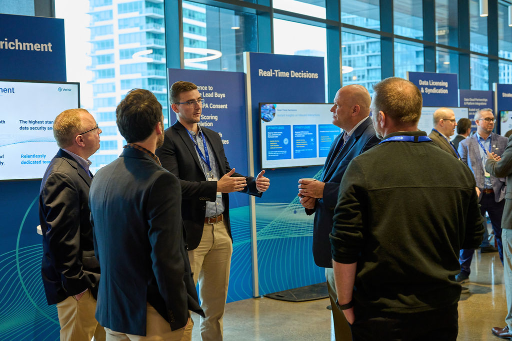 _P2_8311 Business professionals discussing data solutions at a conference.