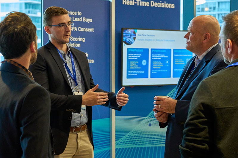 Business professionals discussing real-time decision-making strategies at a conference.
