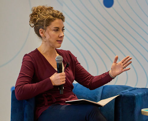 Christine Frohlich, Head of Product and Data Governance at Verisk Marketing Solutions speaks on stage at VIA Chicago