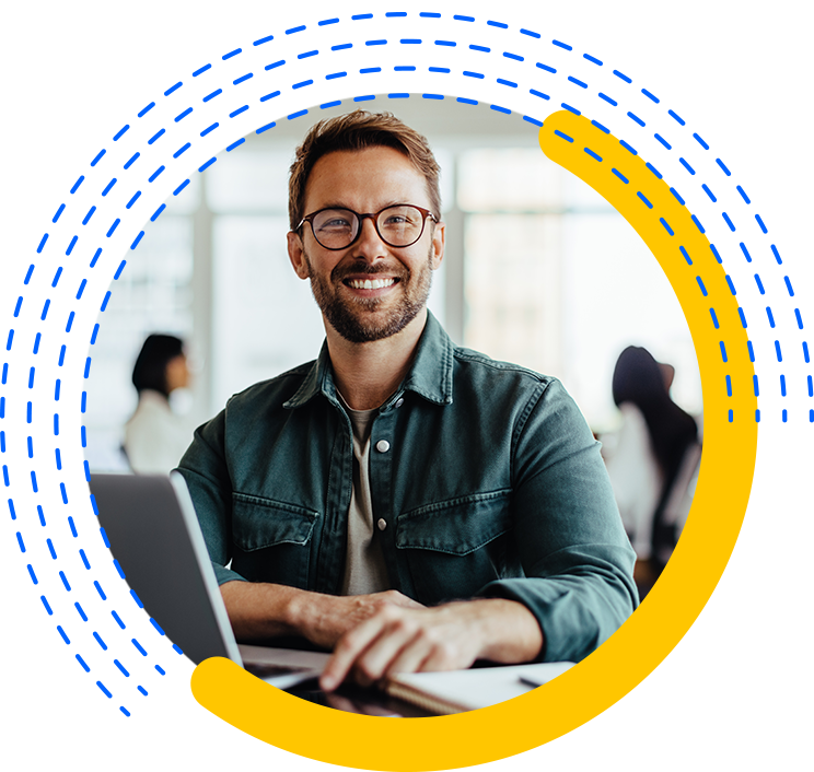 Happy Marketer with Glasses At His Computer